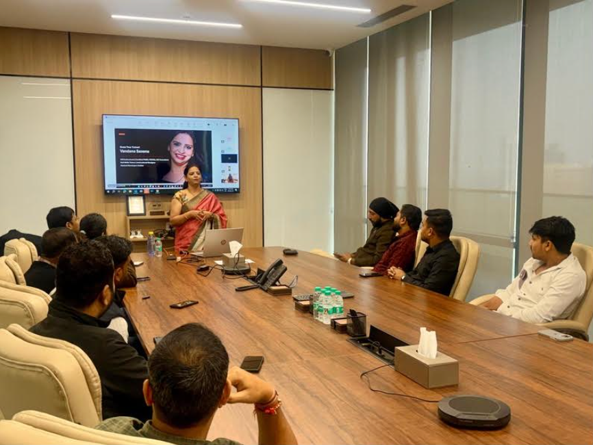 Vandana Saxena presenting to a seated group during a corporate training session